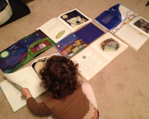 Isabelle searches through a picture book to determine whether or not there's a moon in the illustrations.