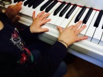Isabelle has to follow rules when she uses the "white piano" at the music studio. Here she's pictured playing with her pointer fingers.